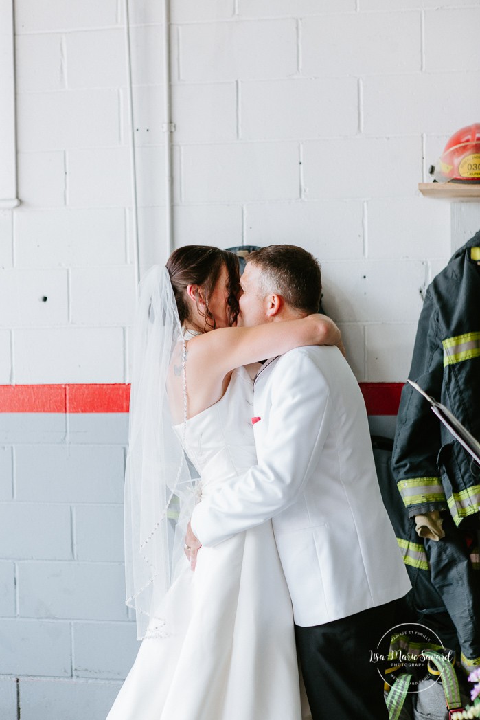 Bride and groom kissing. Wedding inside a real fire station. Mariage dans une caserne de pompier. Mariage à Sainte-Agathe-des-Monts. Photographe de mariage dans les Laurentides. Laurentians wedding photographer.