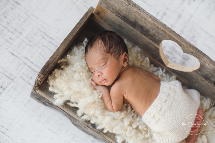 Preemie newborn photos. NICU newborn session. Mixed baby photos. Baby laying on wooden bed.