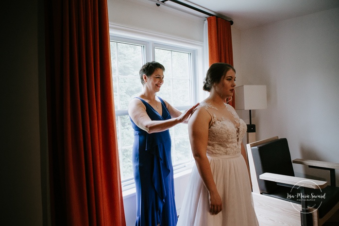 Bride getting ready with mom and maid of honour in hotel room. Auberge de l'Archipel à Saint-Paulin. Préparations des mariés à l'hôtel. Photographe de mariage à Trois-Rivières
