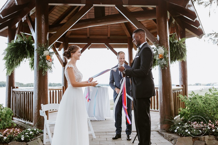 Handfasting ceremony with ribbons. Cérémonie de mariage extérieure au Château Montebello. Fairmont Le Château Montebello outdoor wedding. Ottawa photographer.