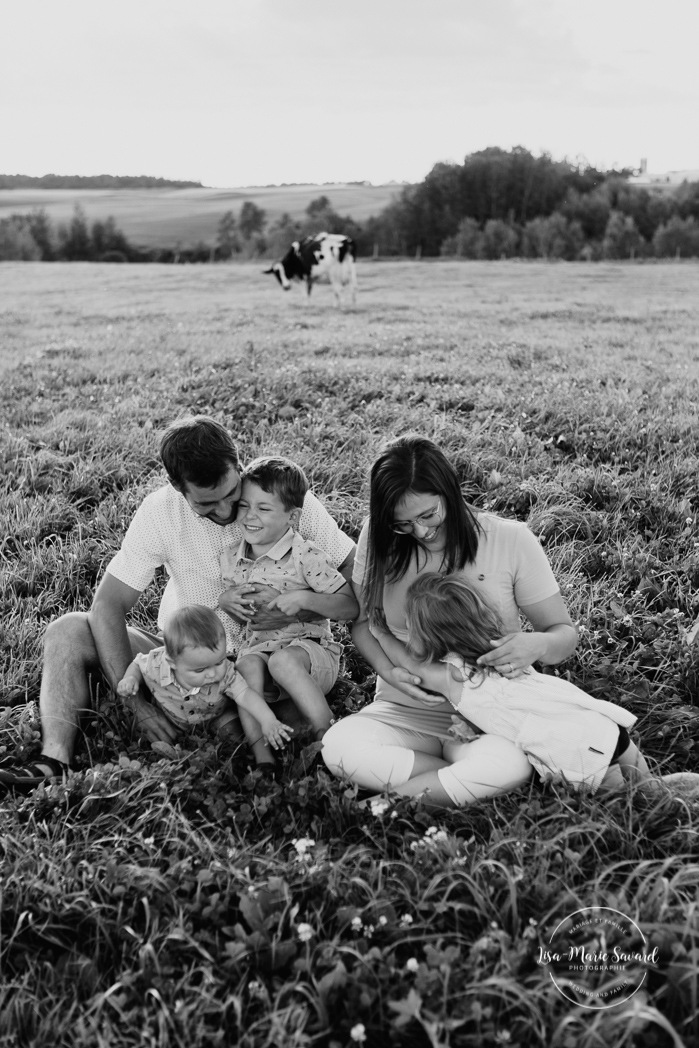 Dairy farm photos with cows. Farm photo session. Family photos with cows. Countryside family photos. Séance photo à la ferme avec des vaches. Séance photo ferme laitière. Photographe de famille à Montréal. Montreal family photographer.