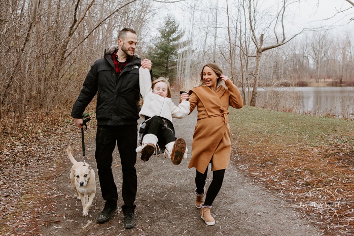 Family photos with dog. Family session with dog. Family walking hand in hand together. Parents swinging child. Maternity photos with child. Maternity photos with sibling. Photos de maternité dans le Sud-Ouest. Photographe de maternité à Ville-Émard. Montreal Southwest maternity photos.