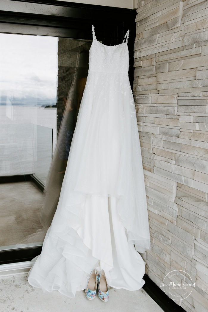 Wedding dress hanging in front of door. Mariage à l'Auberge des Îles à Saint-Gédéon. Photographe mariage Saguenay-Lac-Saint-Jean. Photographe mariage Saguenay. 