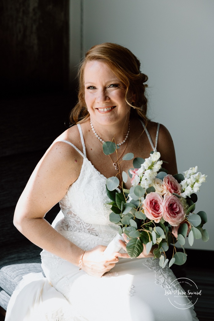 Bride getting ready with bridesmaids in hotel room. Mariage Grand Times Hotel Laval. Mariage à Laval. Laval Grand Times Hotel wedding. Laval wedding photographer.