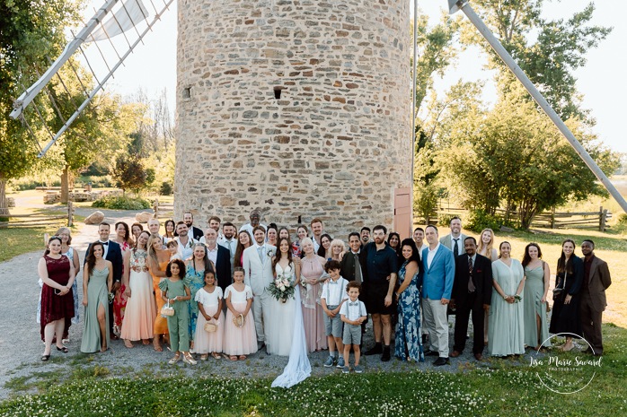 Outdoor wedding ceremony in front of windmill. Mariage à la Pointe-du-Moulin. Photographe mariage à Montréal. Pointe-du-Moulin wedding. Montreal wedding photographer.