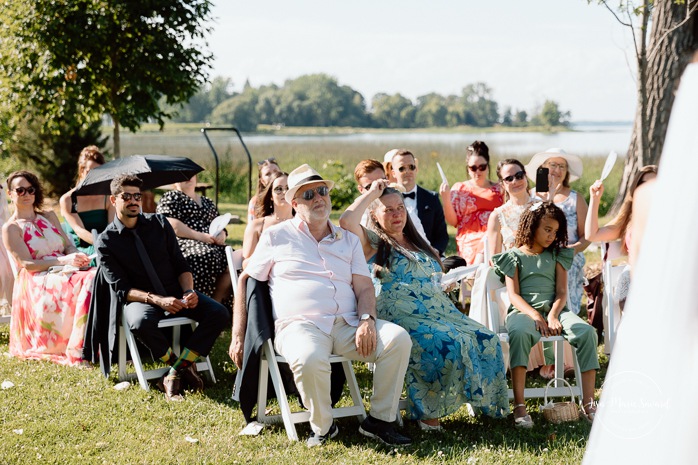 Outdoor wedding ceremony in front of windmill. Mariage à la Pointe-du-Moulin. Photographe mariage à Montréal. Pointe-du-Moulin wedding. Montreal wedding photographer.