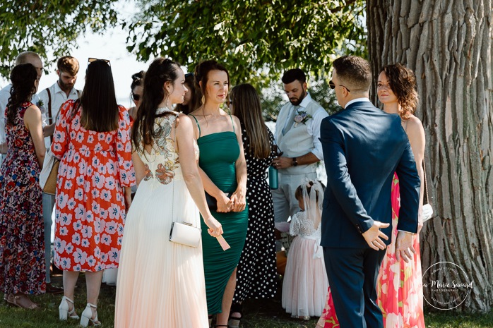 Outdoor wedding ceremony in front of windmill. Mariage à la Pointe-du-Moulin. Photographe mariage à Montréal. Pointe-du-Moulin wedding. Montreal wedding photographer.