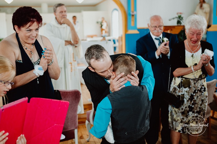 Groom crying after seeing children bride wedding church. Julie et Sabin. Mariage chapelle Saint-Cyriac du Lac Kénogami