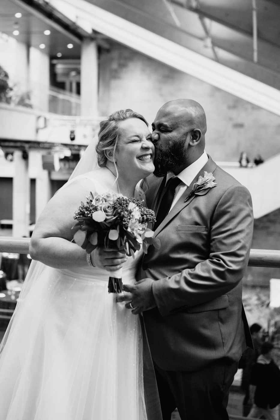 Interracial wedding photos. White bride and brown groom. Wedding photos on rooftop. Mariage au Musée de la Civilisation Québec Mariage dans le Vieux-Québec. Photographe mariage Québec. Old Quebec wedding photos.