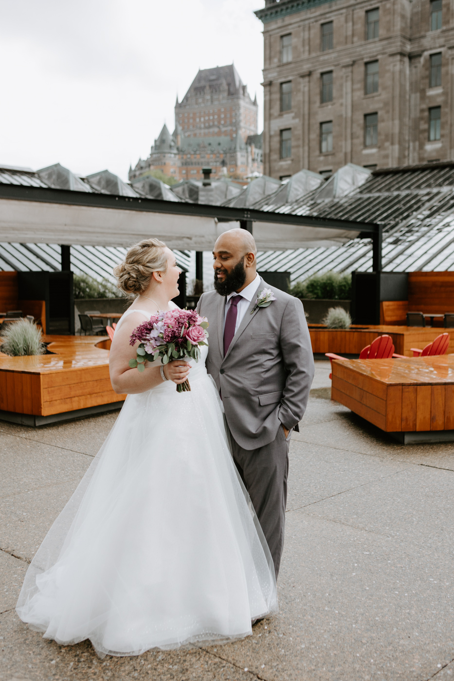 Interracial wedding photos. White bride and brown groom. Wedding photos on rooftop. Mariage au Musée de la Civilisation Québec Mariage dans le Vieux-Québec. Photographe mariage Québec. Old Quebec wedding photos.