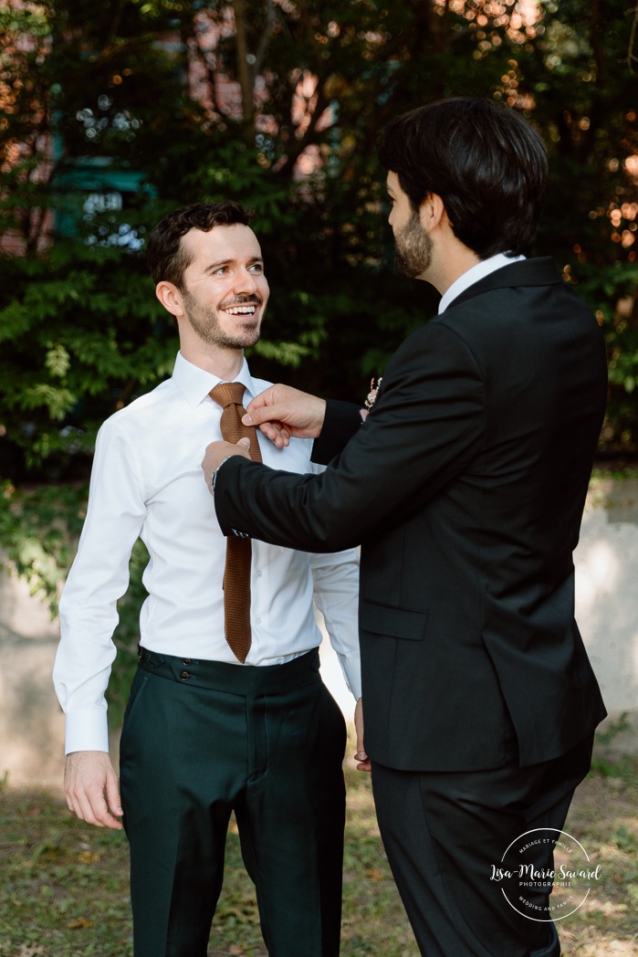 Groom getting ready outdoors with groomsmen. Mariage à l'Ambroisie à Montréal. Photographe de mariage à Montréal. Montreal wedding photographer.