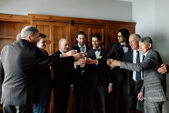 Groom getting ready with groomsmen in wooden cabin. Mariage au Grand Lodge Mont-Tremblant. Photographe de mariage à Mont-Tremblant. Grand Lodge Mont-Tremblant wedding. Mont Tremblant wedding photographer.