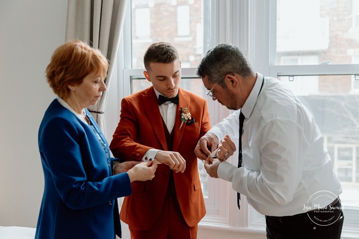 Groom getting ready with family in small apartment. Mariage intime dans le Vieux-Montréal. Photographe de mariage LGBTQ+ friendly à Montréal. Old Montreal intimate wedding photos. Montreal LGBTQ+ friendly photographer.