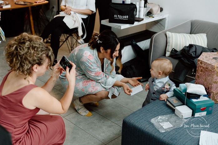 Bride getting ready with bridesmaids in hotel room. Mariage à l'Auberge des Îles au Lac-Saint-Jean. Photographe de mariage au Saguenay-Lac-Saint-Jean.